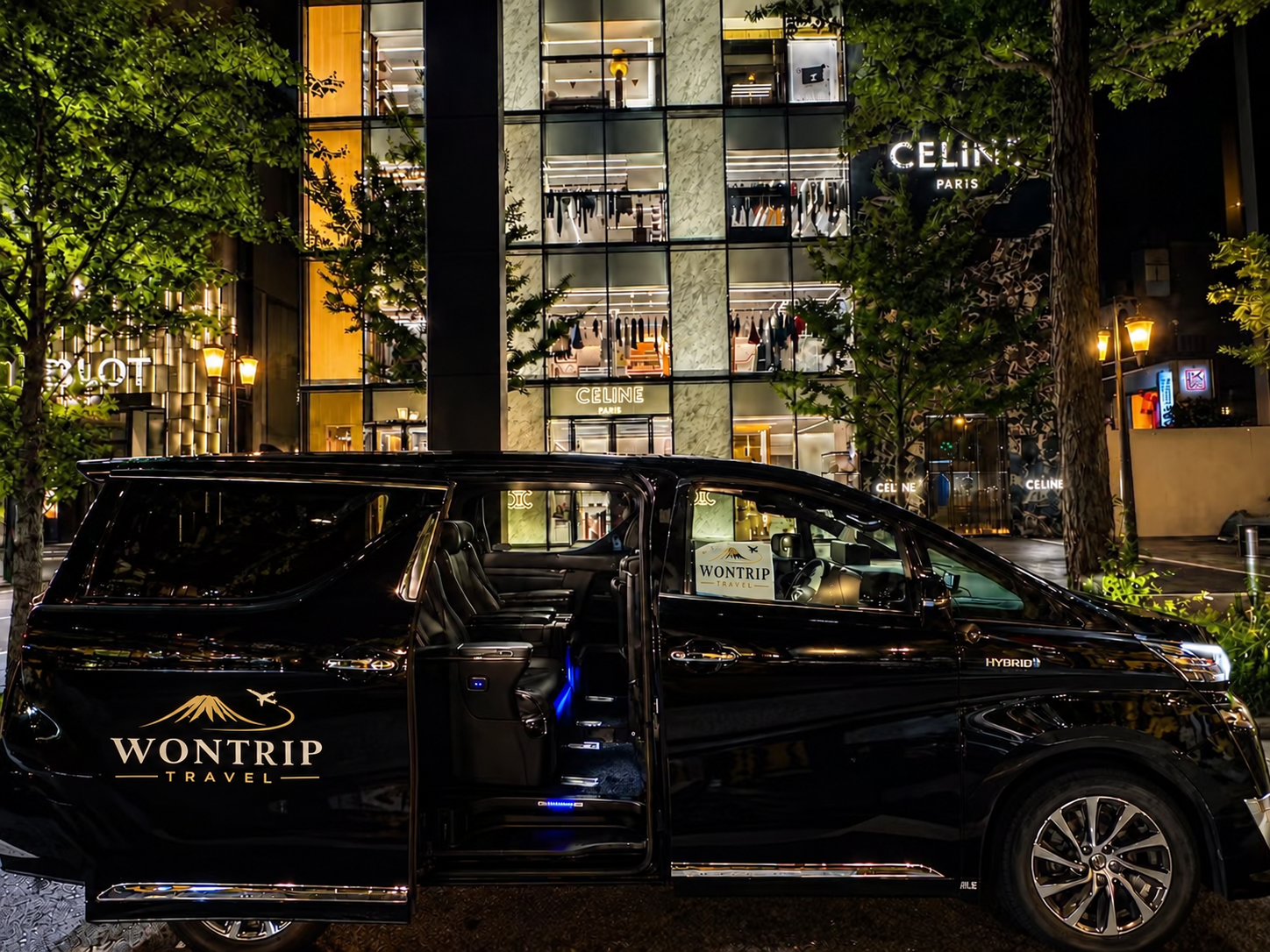 WONTRIP TRAVEL black Toyota Alphard at night with its sliding door open